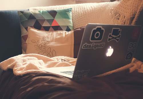 college place MacBook Air on top of sofa home decor